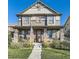 Charming two-story home featuring a welcoming front porch and well-maintained landscaping at 21851 E Tallkid Ave, Parker, CO 80138