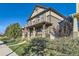 Charming two-story home featuring a welcoming front porch and well-maintained landscaping at 21851 E Tallkid Ave, Parker, CO 80138