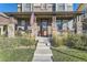 Inviting porch with stone columns and ample seating to enjoy the neighborhood at 21851 E Tallkid Ave, Parker, CO 80138