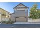 Two-story home featuring a two-car garage with carriage doors and neatly manicured landscaping at 21851 E Tallkid Ave, Parker, CO 80138