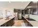 Modern kitchen with stainless steel appliances, white backsplash, and a center island at 21851 E Tallkid Ave, Parker, CO 80138