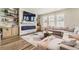 Bright living room with a stone fireplace, floating shelves, and lots of natural light at 21851 E Tallkid Ave, Parker, CO 80138