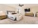 Large main bedroom featuring a ceiling fan, TV, and a comfortable sitting bench at 21851 E Tallkid Ave, Parker, CO 80138