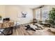 Bright office space with a wooden desk, stylish seating, and a unique cowhide rug adding charm at 21851 E Tallkid Ave, Parker, CO 80138