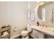 Cozy powder room with modern fixtures, decorative artwork, and a pedestal sink at 21851 E Tallkid Ave, Parker, CO 80138