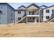 Two-story home featuring a covered patio, backyard, and stairs leading to the second floor balcony at 11902 Octave Ave, Parker, CO 80134