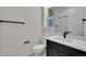 Modern bathroom featuring a white vanity with a black faucet and hardware, complemented by white walls and a tile shower at 11902 Octave Ave, Parker, CO 80134