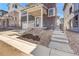 Landscaped front yard featuring stone and wood chip accents and concrete walkways to the entrance at 11902 Octave Ave, Parker, CO 80134