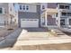 Exterior view of a gray home with a two-car garage and drought-tolerant landscaping at 11902 Octave Ave, Parker, CO 80134
