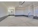 Spacious and unfinished two car garage with stairs to an entry door and natural light from a window at 11902 Octave Ave, Parker, CO 80134