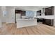 Modern kitchen with island, stainless steel appliances, and ample natural light at 11902 Octave Ave, Parker, CO 80134