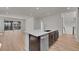 Modern kitchen featuring a large island, stainless steel appliances, and light wood floors at 11902 Octave Ave, Parker, CO 80134