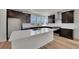 Open kitchen featuring stainless steel appliances, white countertops, and dark cabinets at 11902 Octave Ave, Parker, CO 80134