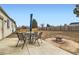 Large backyard with patio area, dining set, and fire pit, perfect for outdoor entertaining and relaxation at 4828 S Nucla Way, Aurora, CO 80015
