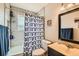Bathroom featuring a tub with shower and a vanity with a framed mirror at 4828 S Nucla Way, Aurora, CO 80015