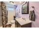 Updated bathroom with sleek vanity, modern fixtures, decorative mirror, and shower with a stylish curtain at 4828 S Nucla Way, Aurora, CO 80015
