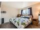 Cozy bedroom with a comfortable bed, neutral walls, and a window providing natural light at 4828 S Nucla Way, Aurora, CO 80015