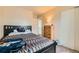 Comfortable bedroom featuring a wooden bed frame and light-colored walls for a serene atmosphere at 4828 S Nucla Way, Aurora, CO 80015