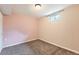 Cozy bedroom with neutral carpeting, light pink walls, and a bright window for natural light at 4828 S Nucla Way, Aurora, CO 80015