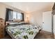 Bedroom featuring a cozy bed, natural light, and a serene atmosphere at 4828 S Nucla Way, Aurora, CO 80015
