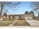 Charming brick home with a well-maintained lawn and attached two-car garage at 4828 S Nucla Way, Aurora, CO 80015