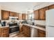 Well-equipped kitchen featuring stainless steel appliances, and wood cabinetry at 4828 S Nucla Way, Aurora, CO 80015