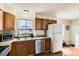 Functional kitchen with stainless steel appliances, ample counter space, and wood cabinets at 4828 S Nucla Way, Aurora, CO 80015