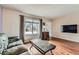 Comfortable living room featuring hardwood floors, a large window, and neutral decor at 4828 S Nucla Way, Aurora, CO 80015