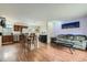 Open-concept living space with wood floors, connecting the living room to the kitchen and dining area at 4828 S Nucla Way, Aurora, CO 80015