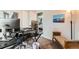 Functional office space with a desk setup, natural light, and a view into an adjacent bedroom at 4828 S Nucla Way, Aurora, CO 80015