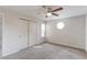 Neutral carpeted bedroom with ceiling fan, closet, and uniquely shaped window at 12180 Melody Dr # 203, Westminster, CO 80234