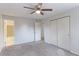 Bright carpeted bedroom with a ceiling fan, closet, and an adjoining bathroom at 12180 Melody Dr # 203, Westminster, CO 80234