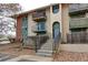 Multi-story building with patios, stone stairs and a neutral color palette at 12180 Melody Dr # 203, Westminster, CO 80234