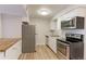 This updated kitchen has stainless steel appliances, white cabinets, and granite countertops at 12180 Melody Dr # 203, Westminster, CO 80234