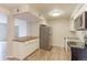 This kitchen features an island, stainless steel refrigerator, granite countertops, and modern appliances at 12180 Melody Dr # 203, Westminster, CO 80234