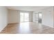 Spacious living room with hardwood floors, balcony access and views, and an open layout at 12180 Melody Dr # 203, Westminster, CO 80234