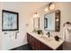 Bathroom with double vanity featuring modern fixtures, a large window, and ample counter space at 19185 Shadowood Dr, Monument, CO 80132