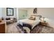 This cozy bedroom has modern decor, a comfortable bed, and a picturesque view from the window at 19185 Shadowood Dr, Monument, CO 80132