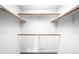 Spacious walk-in closet with wooden shelving and ample storage space for clothing and accessories at 19185 Shadowood Dr, Monument, CO 80132