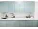 Stylish counter space with light blue cabinets, a marble countertop, and decorative accents at 19185 Shadowood Dr, Monument, CO 80132