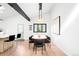 Bright dining area with modern lighting, seating for six, and view into an open kitchen featuring skylights at 19185 Shadowood Dr, Monument, CO 80132