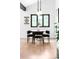 Dining area with modern lighting, dark wood table with seating for six, and a large window with tree views at 19185 Shadowood Dr, Monument, CO 80132