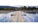 Picturesque dock extending over a partially frozen lake with mountain views in the background at 19185 Shadowood Dr, Monument, CO 80132
