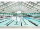 Bright indoor pool area featuring marked lanes and a clear, airy design at 19185 Shadowood Dr, Monument, CO 80132