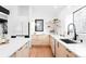 Modern kitchen featuring light wood cabinets, white countertops, and an island with seating, perfect for entertaining at 19185 Shadowood Dr, Monument, CO 80132