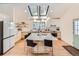 Bright, open kitchen with large island, skylights, white countertops, and stainless-steel appliances at 19185 Shadowood Dr, Monument, CO 80132