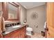 Elegant powder room featuring a granite countertop and decorative mirror at 8136 S Glencoe Ct, Centennial, CO 80122