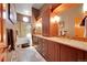 Bathroom with double vanity, cabinet storage, and walk-in shower with glass door at 8136 S Glencoe Ct, Centennial, CO 80122