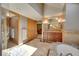 Bright bathroom with dual sink vanity, walk-in shower, and an open doorway to the main bedroom at 8136 S Glencoe Ct, Centennial, CO 80122