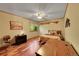 Cozy bedroom featuring wood floors, a ceiling fan, and a comfortable bed at 8136 S Glencoe Ct, Centennial, CO 80122